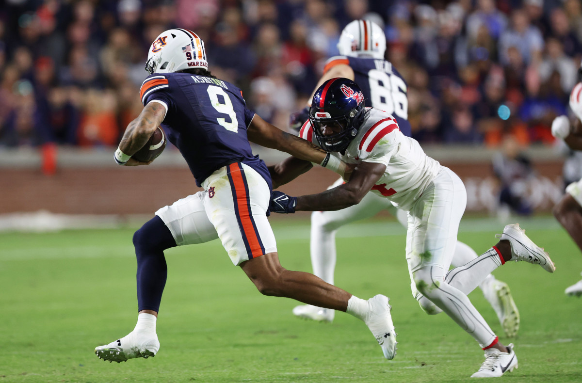 Oct 21, 2023; Auburn, Alabama, USA; Mississippi Rebels linebacker Suntarine Perkins (4) chases down Auburn Tigers quarterback Robby Ashford (9) during the third quarter at Jordan-Hare Stadium. Mandatory Credit: John Reed-USA TODAY Sports  